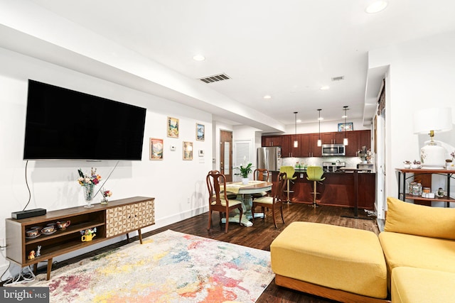 living room with dark hardwood / wood-style flooring