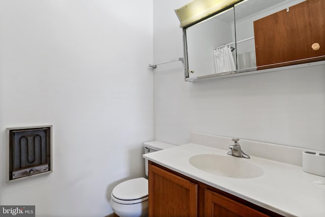 bathroom featuring vanity, toilet, and walk in shower