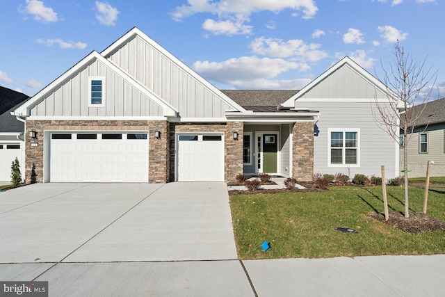 view of front of property featuring a garage and a front lawn