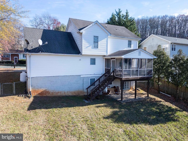 rear view of property featuring a patio area, a sunroom, and a yard