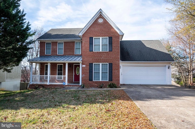 view of front of property featuring a front lawn, covered porch, and a garage