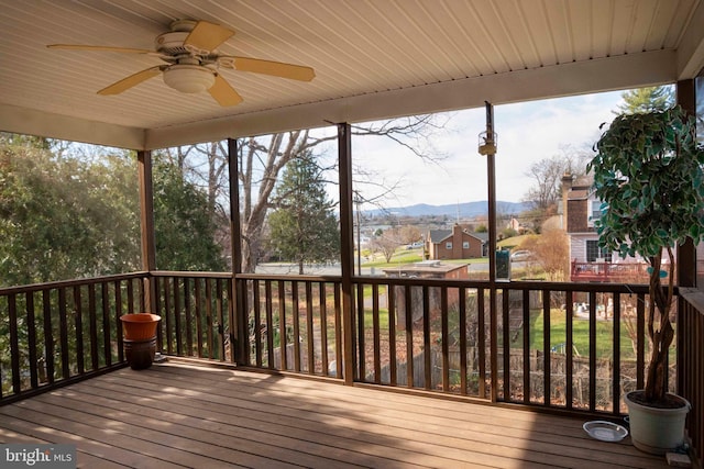 wooden deck with a mountain view and ceiling fan