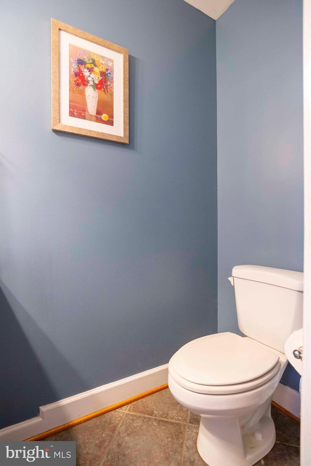 bathroom with tile patterned flooring and toilet