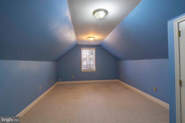 bonus room with carpet flooring and lofted ceiling