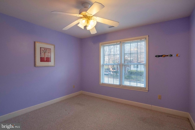 carpeted empty room featuring ceiling fan