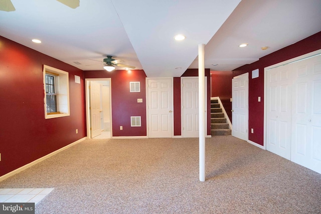 basement with light carpet and ceiling fan