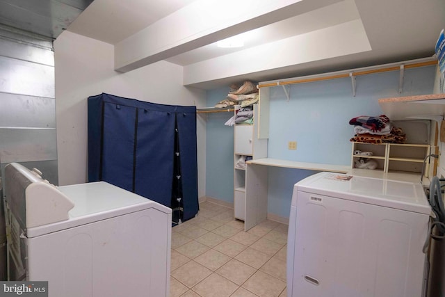 washroom featuring washer and dryer and light tile patterned flooring