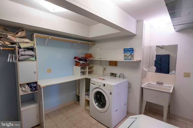 laundry area with light tile patterned flooring and washer / dryer