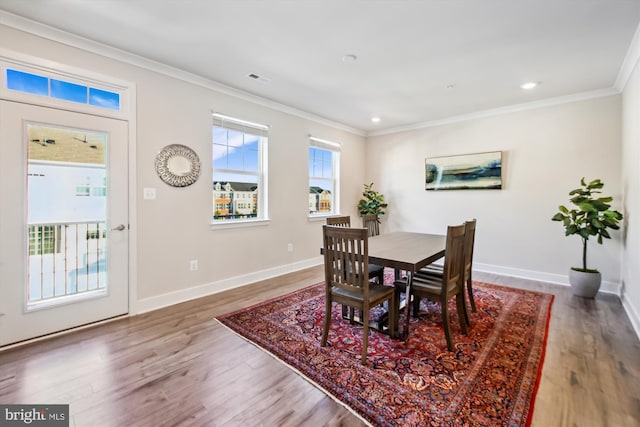 dining room featuring hardwood / wood-style floors and ornamental molding