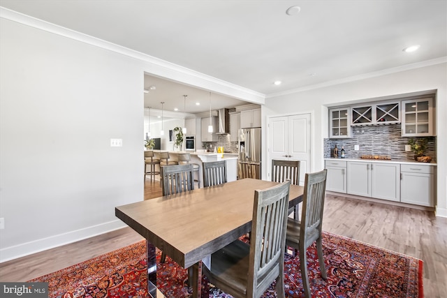 dining room featuring crown molding and wood-type flooring