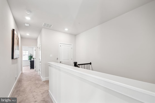 corridor with light colored carpet