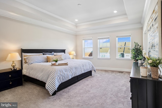 bedroom featuring crown molding, a raised ceiling, and light carpet