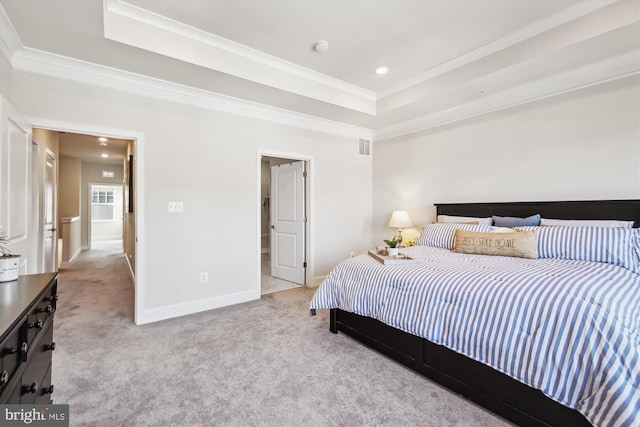 carpeted bedroom featuring connected bathroom, a raised ceiling, and crown molding