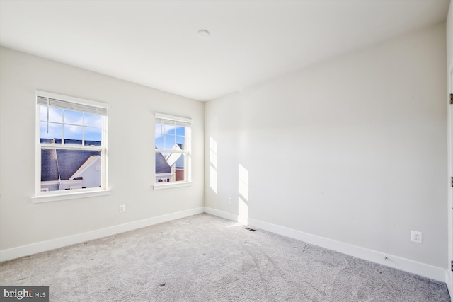 empty room featuring light colored carpet