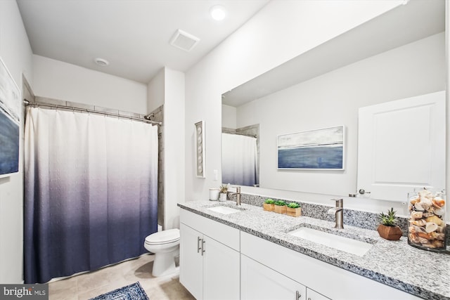 bathroom with tile patterned flooring, vanity, curtained shower, and toilet