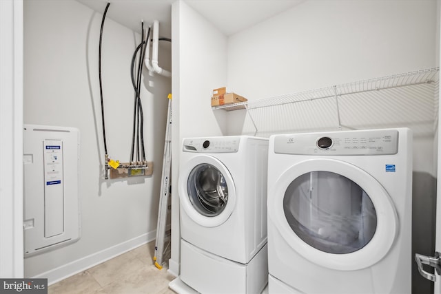 laundry area featuring light tile patterned floors and washing machine and clothes dryer