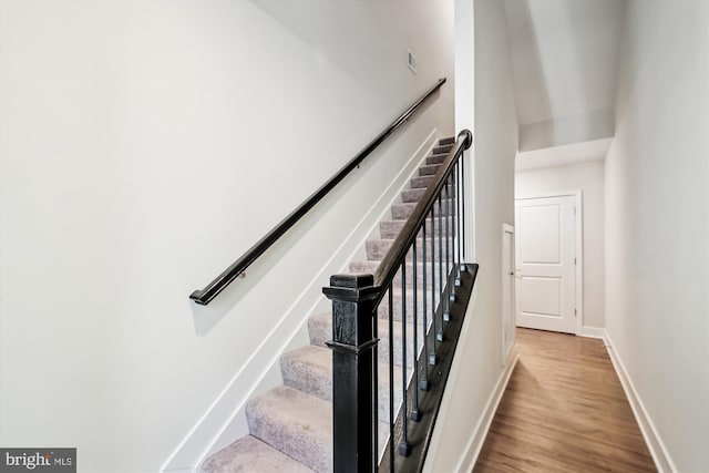 staircase featuring wood-type flooring