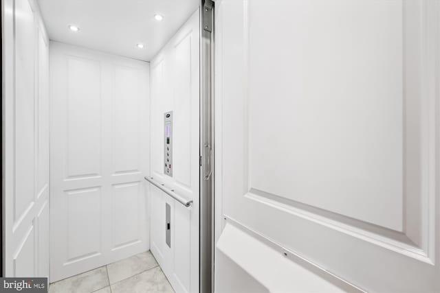 bathroom featuring tile patterned floors and elevator