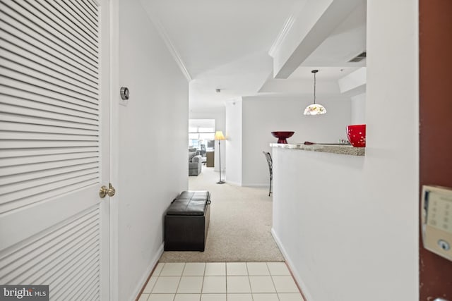 hallway with light carpet and ornamental molding