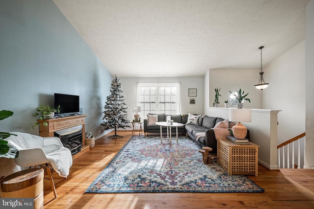 living room with wood-type flooring and a textured ceiling