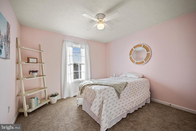 carpeted bedroom featuring ceiling fan and a textured ceiling