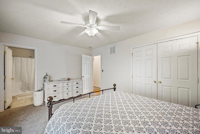 bedroom with connected bathroom, ceiling fan, a textured ceiling, a closet, and carpet