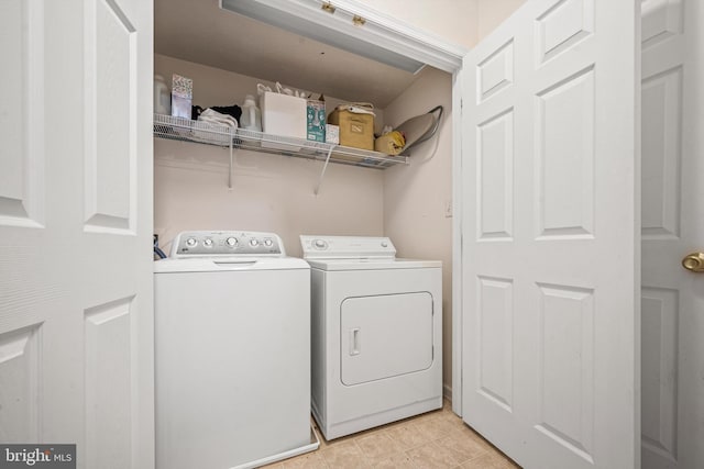 laundry room featuring light tile patterned flooring and washing machine and clothes dryer