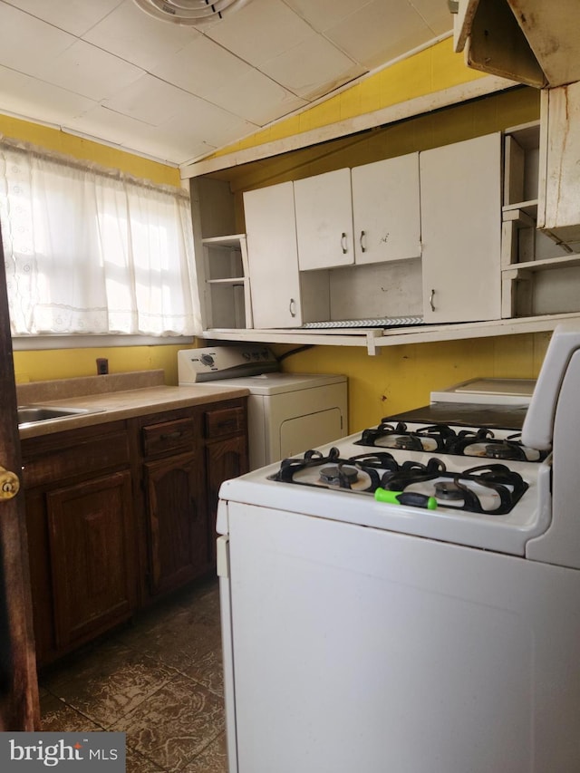 kitchen featuring dark brown cabinetry and washer / clothes dryer