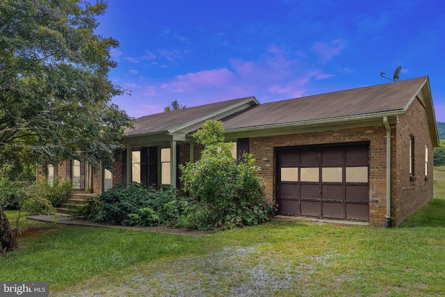 single story home with a lawn and a garage