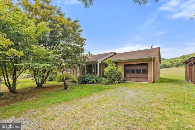 view of front of property with a front lawn and a garage