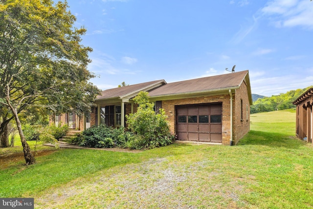 view of front of house with a garage and a front lawn