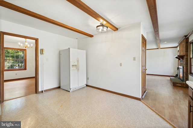 empty room with beamed ceiling and an inviting chandelier