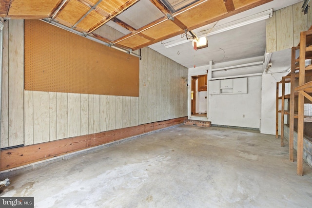 garage featuring wood walls and a garage door opener