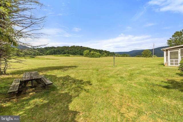 view of yard with a mountain view and a rural view