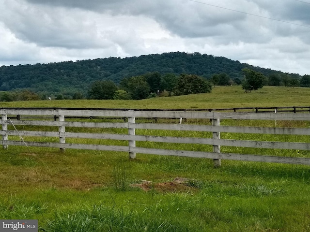 view of gate with a rural view