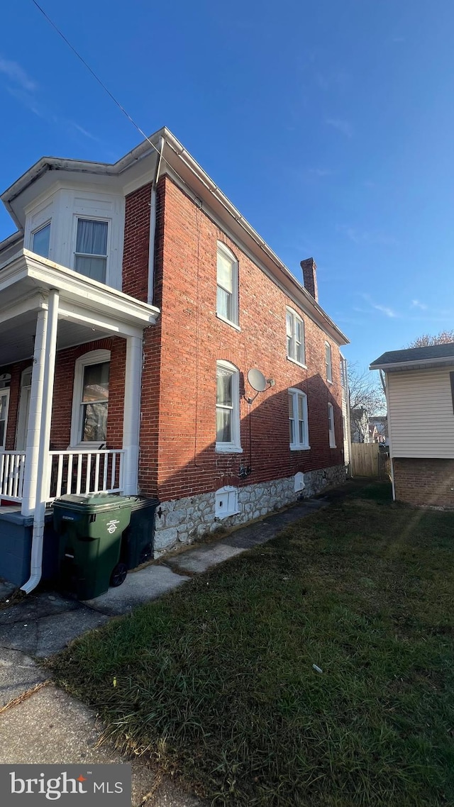 view of side of home featuring a lawn