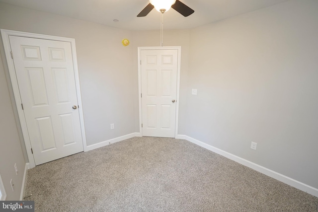 carpeted empty room featuring ceiling fan