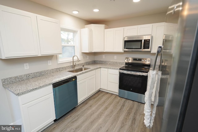 kitchen featuring sink, white cabinetry, and stainless steel appliances