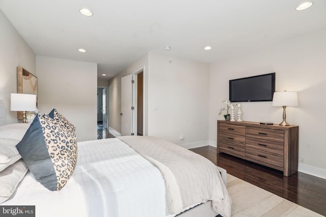 bedroom with dark wood-type flooring