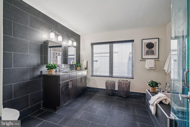 bathroom featuring vanity, tile patterned flooring, and a shower with door