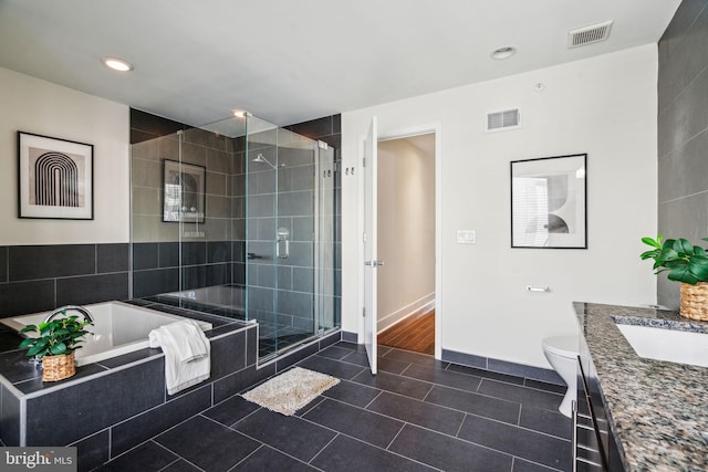 full bathroom featuring shower with separate bathtub, toilet, tile patterned flooring, and vanity