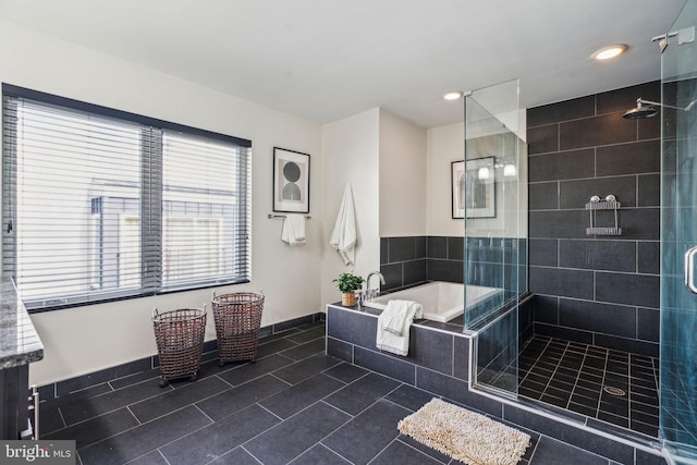 bathroom featuring tile patterned floors and separate shower and tub