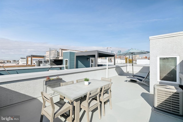 view of patio with central AC and a balcony