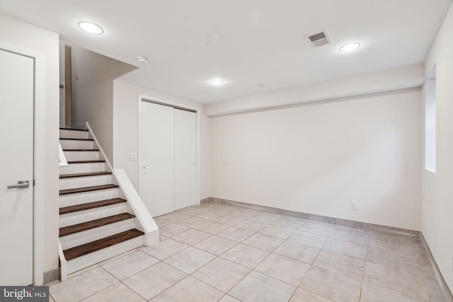 basement featuring light tile patterned flooring