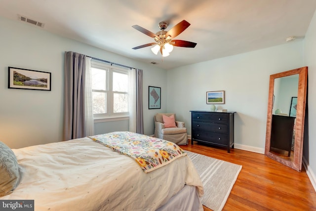 bedroom with ceiling fan and light hardwood / wood-style floors