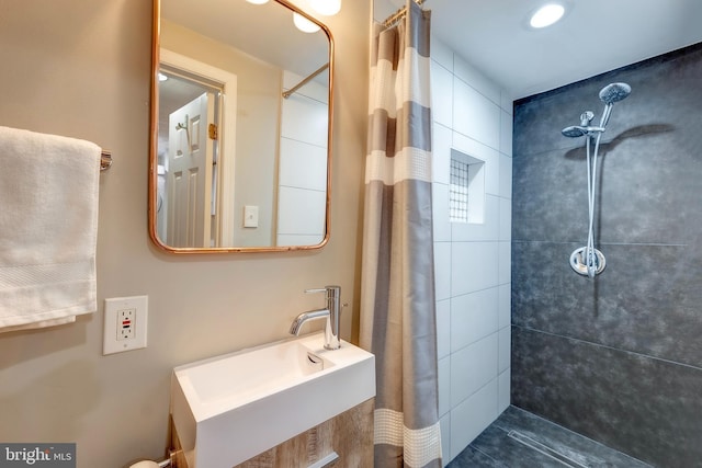 bathroom with curtained shower and sink