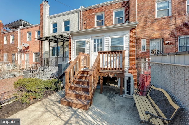 back of property featuring central AC unit