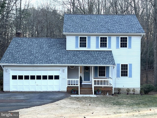 view of front of property with covered porch and a garage