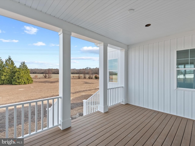 wooden deck with a rural view