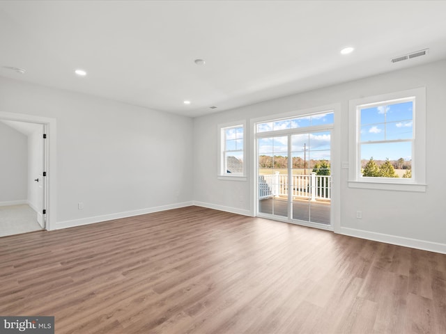 spare room with light hardwood / wood-style floors